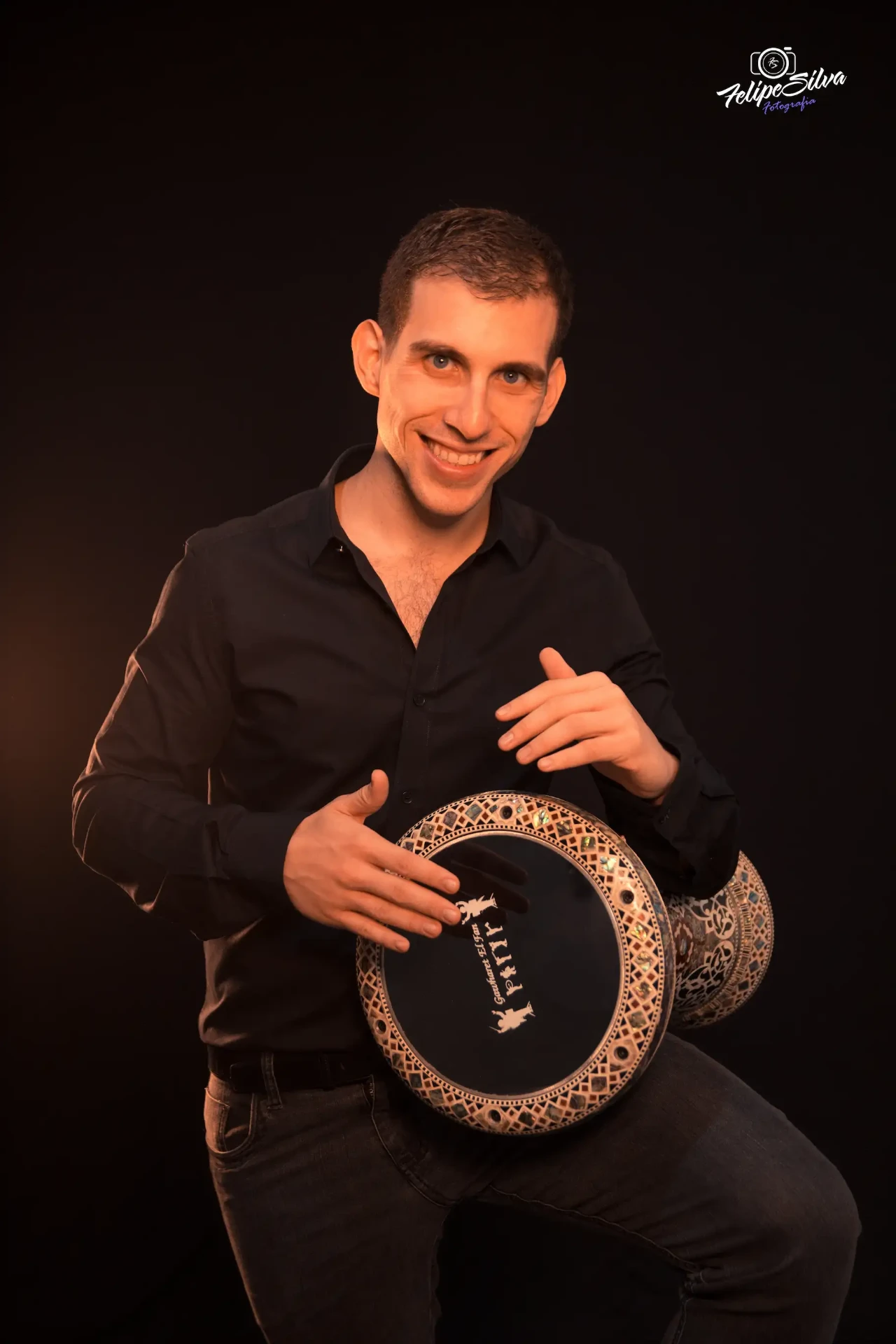Pedro Françolin holding a traditional Arabic percussion instrument